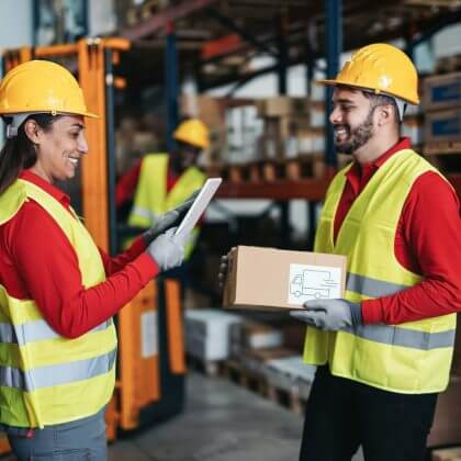 Multiracial warehouse worker with package and digital tablet