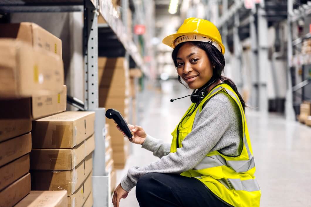 Portrait of african american engineer woman scanning package with barcode scanner check goods in transportation and distribution in warehouse logistic Industrial and business export